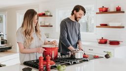 Couple cooking in a white kitchen