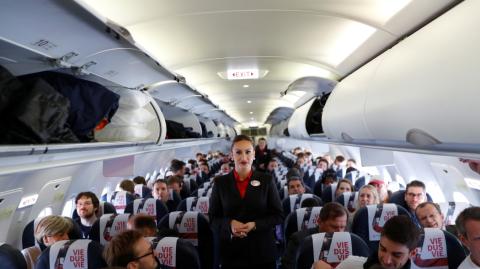 Azafata en un avión de pasajeros Azafata en un avión de pasajeros